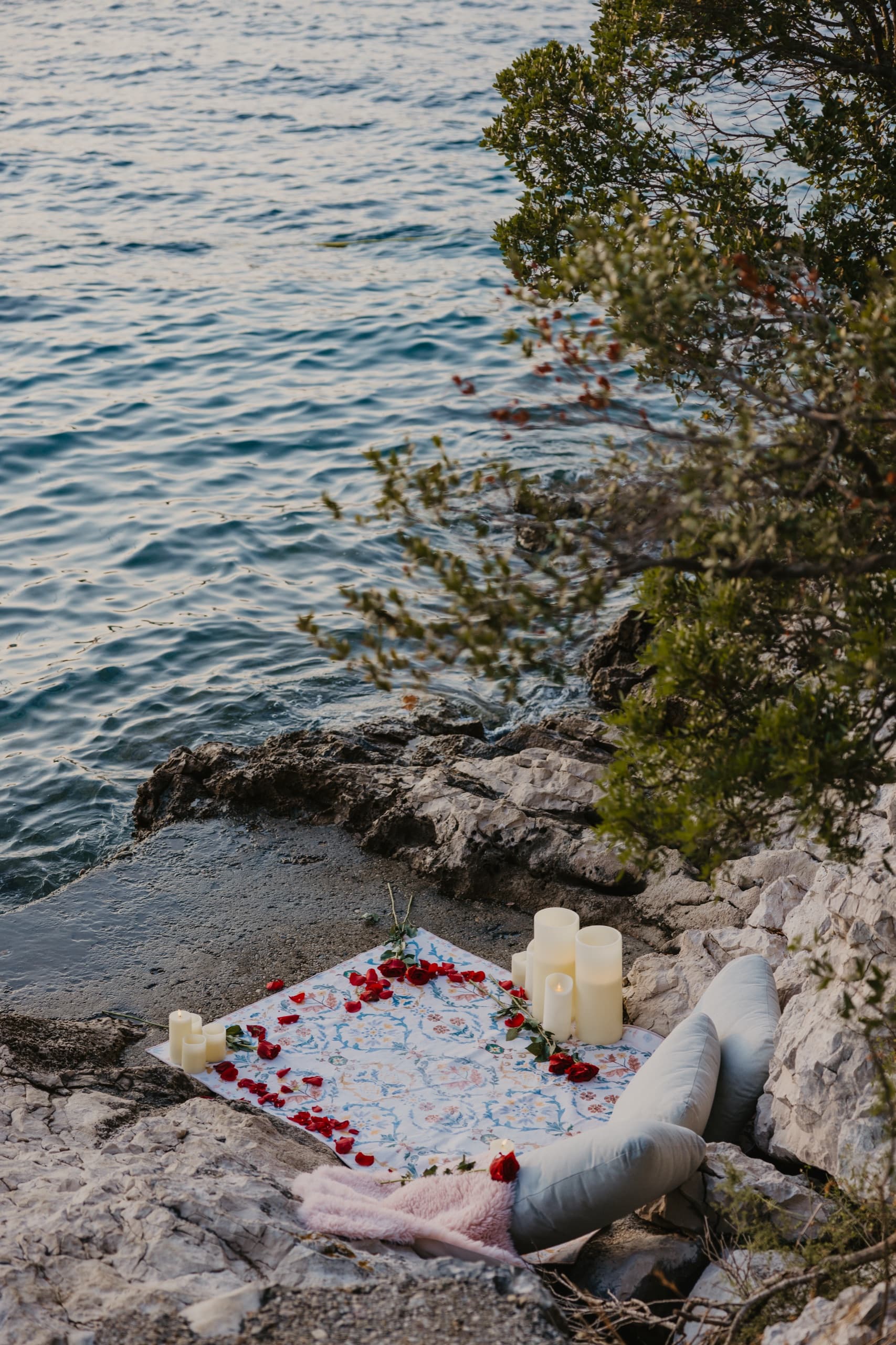 The rocky Korčula coast at golden hour, the still sea beyond