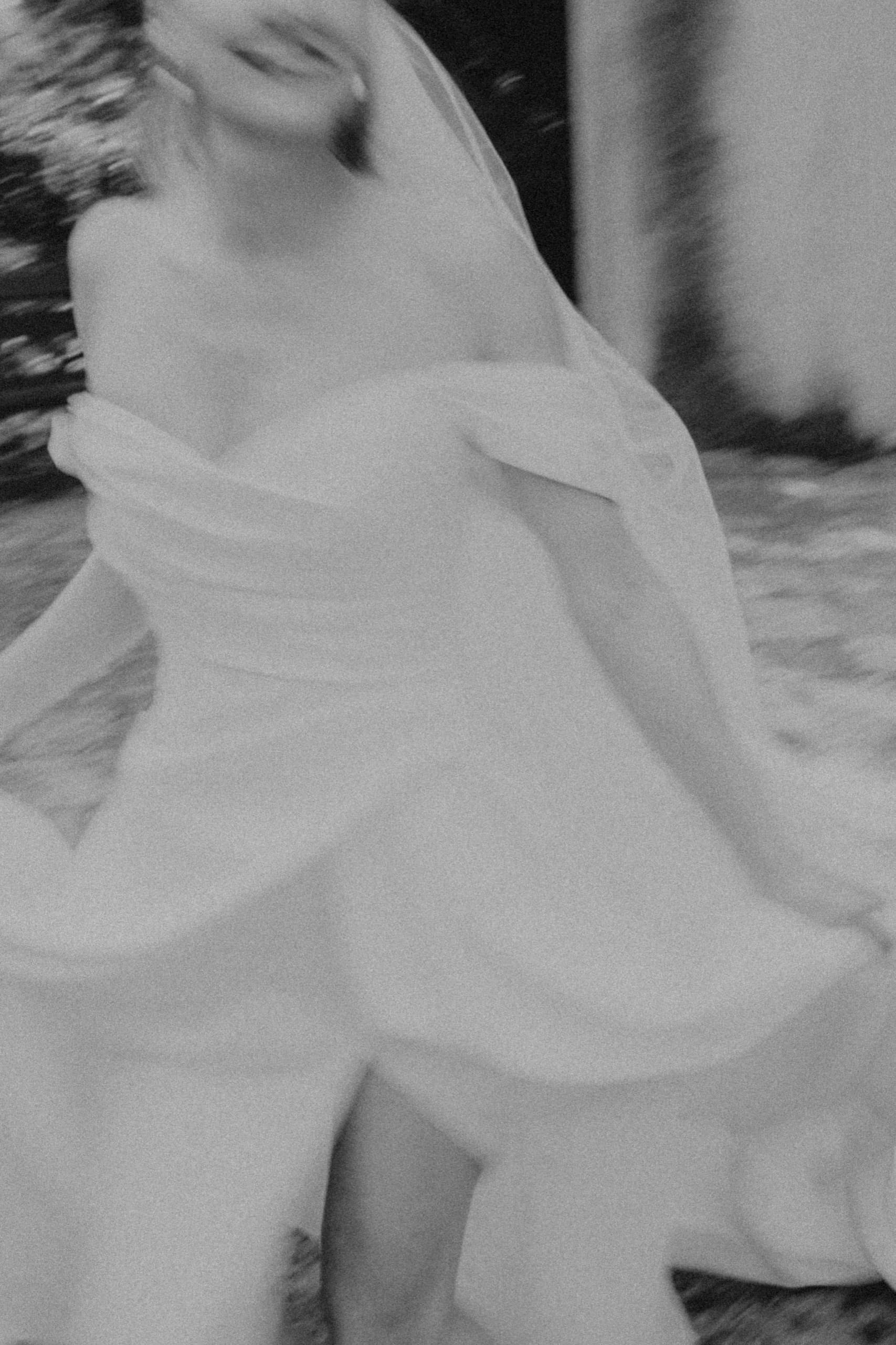 Bride turning in her flowing gown, black and white
