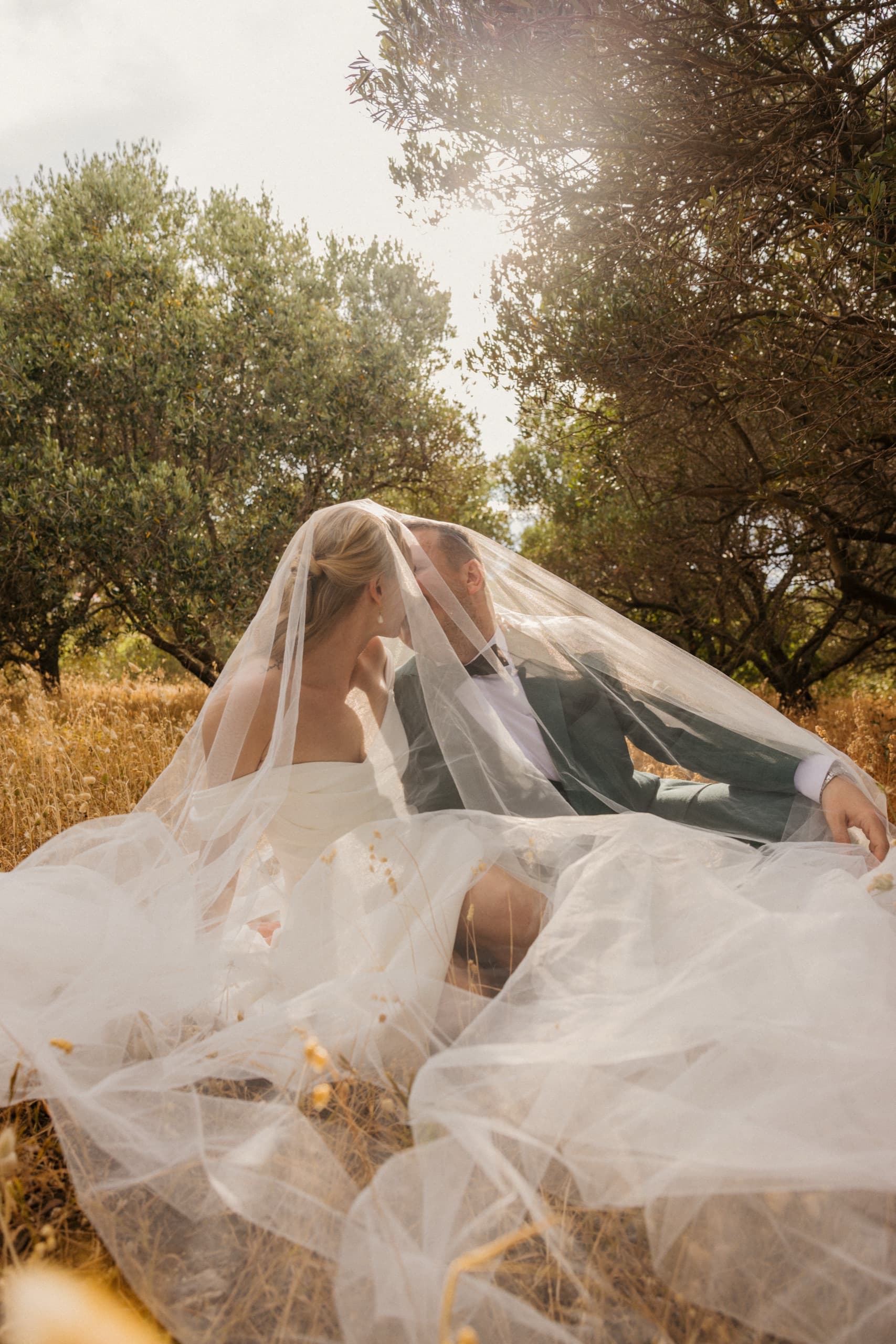Bride in the golden field, her veil catching the light