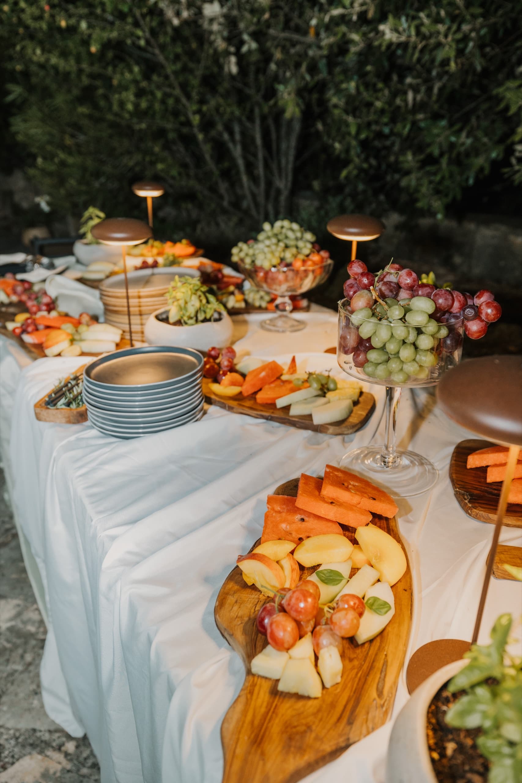 Grazing table of fruit, cheese and local dishes with gold candlesticks