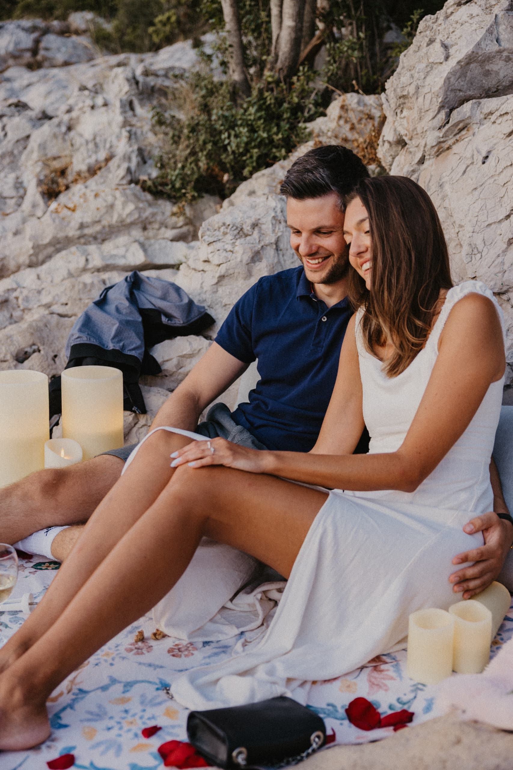 A couple together on the shore as evening falls
